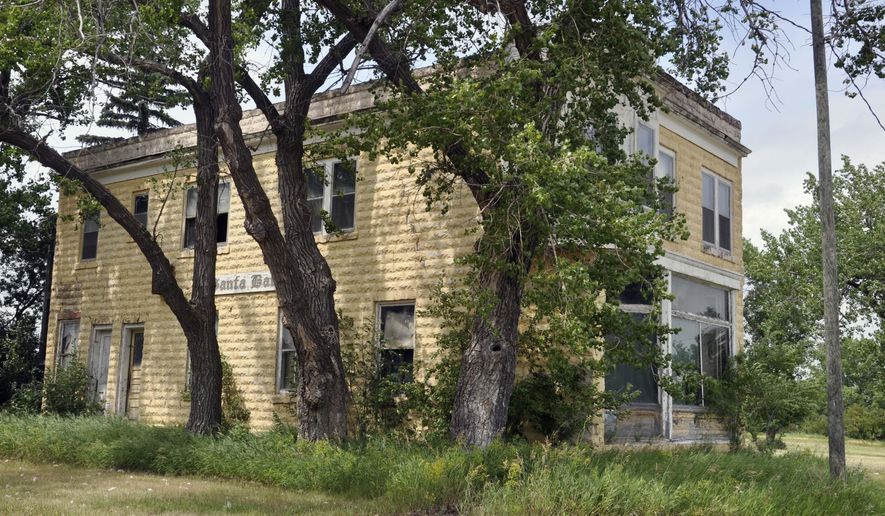 This July 15, 2015 photo provided by Grant County ND Dot Com shows a nearly century-old vacant bank building in Antler, N.D., that the town plans to demolish on Feb. 29. White supremacist Craig Cobb once tried to buy the building to convert into a church for his religion, but city officials thwarted his plans by buying up all of the town’s vacant property, including the old bank. (Gregory Bruce/Grant County ND Dot Com via AP)