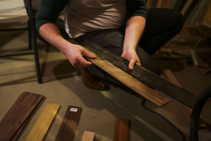 In this Feb. 12, 2016, photo, Thomas Larsen works on a banjo in his basement workshop in American Fork, Utah. Working on banjos is one of the many musical inspirations Larsen finds in his every day life. (Dominic Valente/The Daily Herald via AP) MANDATORY CREDIT