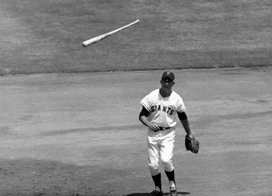 FILE - In this July 16, 1967, file photo, San Francisco Giants third baseman Jim Davenport looks at the bat thrown by Chicago Cubs' Adolfo Phillips in the second inning of a baseball game in San Francisco. Jim Davenport, a longtime third baseman for the Giants who later managed the team and worked in the front office, has died. He was 82. The Giants announced his death Friday, Feb. 19, 2016, saying he died Thursday night in Redwood City, Calif.,, because of heart failure. (AP Photo/File)