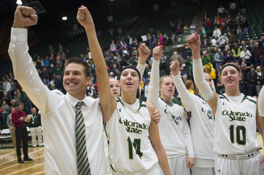 In this Saturday, Nov. 21, 2015, photo, Colorado State coach Ryun Williams and his team celebrate a 61-55 win in an NCA college basketball game against BYU at Moby Arena in Fort Collins, Colo. The Lady Rams have reeled off a school-record 20 straight wins as the team chases an NCAA tournament bid for the first time since 2002. (Austin Humphreys/Fort Collins Coloradoan via AP)