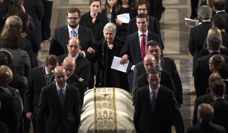 Widow Maureen McCarthy Scalia, walks behind the casket as it is ushered out of the Bascilica following the funeral mass for the late Supreme Court Associate Justice Antonin Scalia, at the Basilica of the National Shrine of the Immaculate Conception in Washington, Saturday, Feb. 20, 2016.  (Doug Mills/The New York Times via AP, Pool)