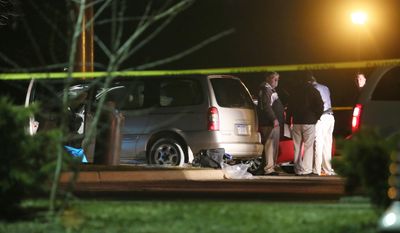 Police investigate the scene early Sunday, Feb. 21, 2016, where people were shot in vehicles outside a Cracker Barrel restaurant in Kalamazoo, Mich. A man drove around Kalamazoo shooting people at three locations Saturday, leaving six dead and three injured, two of them critically, police said. Police have arrested the suspect in the Saturday, Feb. 20, multiple shootings. (Mark Bugnaski/Kalamazoo Gazette) MANDATORY CREDIT