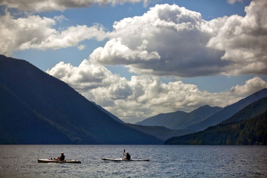 In this July 5, 2013 photo, kayakers paddle in the teal-blue waters of Lake Crescent, in Olympic National Park. At more than 600 feet deep, the nitrogen-deprived waters don’t support algae growth, keeping the lake crystal clear. (Bettina Hansen/The Seattle Times via AP) SEATTLE OUT; USA TODAY OUT; MAGS OUT; TELEVISION OUT; NO SALES; MANDATORY CREDIT BETTINA HANSEN/SEATTLE TIMES