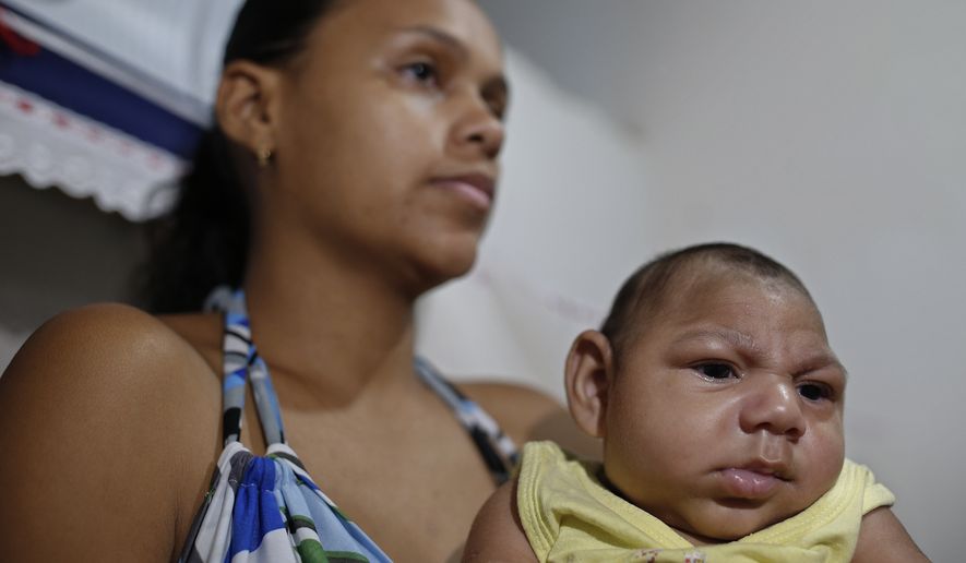Janine Santos holds her 3-month-old son Shayde Henrique who was born with microcephaly while health workers visit her home in Joao Pessoa, Brazil, Tuesday, Feb. 23, 2016. (AP Photo/Andre Penner) ** FILE **