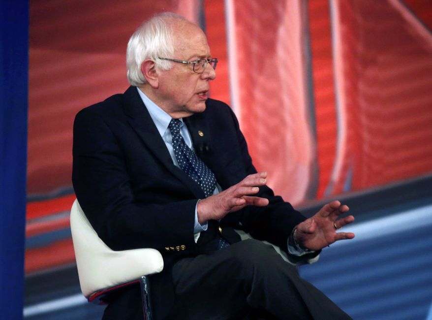 Democratic presidential candidate, Sen. Bernie Sanders, I-Vt., talks with host Chris Cuomo during commercial break in a CNN town hall style televised event at the University of South Carolina School of Law, in Columbia, S.C., Tuesday, Feb. 23, 2016. (AP Photo/Gerald Herbert)