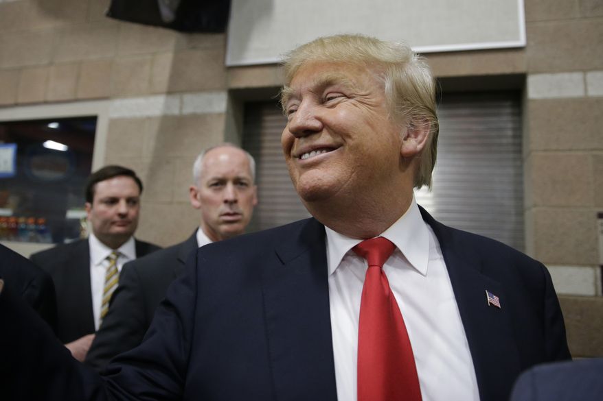 Republican presidential candidate Donald Trump smiles as he greets voters at a caucus site in this Tuesday, Feb. 23, 2016, file photo, in Las Vegas. (AP Photo/Jae C. Hong) ** FILE **