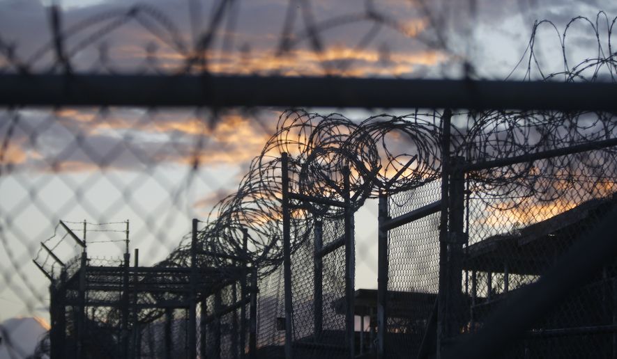 In this Nov. 21, 2013, file photo reviewed by the U.S. military, dawn arrives at the now closed Camp X-Ray at the Guantanamo Bay Naval Base in Cuba — a camp that was used as the first detention facility for al Qaeda and Taliban militants who were captured after the Sept. 11, 2001, attacks on the U.S. (AP Photo/Charles Dharapak, File)