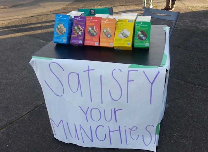 A business-savvy Girl Scout is funding her trip to horse camp by setting up her cookie stand outside a marijuana dispensary in Portland, Oregon. (KATU/Corry Young)