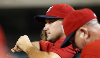In this photo taken Aug. 4, 2014, Washington Nationals Ryan Zimmerman pauses in the dugout during a baseball game against the Philadelphia Phillies at Nationals Park in Washington. In his first interview since reporting to spring training, Zimmerman vigorously defended himself against performance-enhancing drug allegations made in a documentary that aired in December. (AP Photo/Alex Brandon)