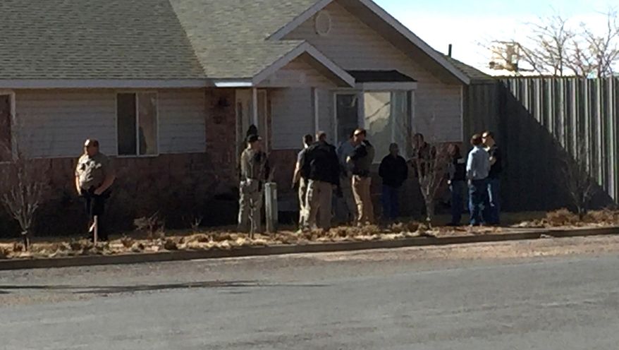 This photo provided by Andrew Chatwin shows law enforcement officers conducting a search at the Wedgewood Development construction company in Hildale, Utah on Tuesday, Feb. 23, 2016. Police are searching businesses in the polygamous town on the Utah-Arizona border. The U.S. Attorney's Office in Utah said in statement Tuesday that federal, state and local authorities are carrying out actions approved by a court. Officials didn't elaborate, saying court documents are sealed. (Andrew Chatwin via AP)