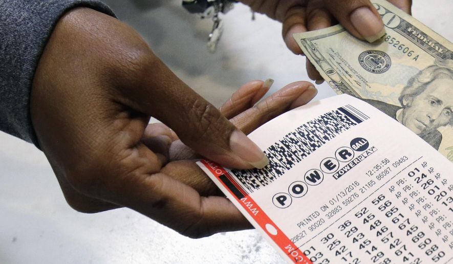 In this Jan. 13, 2016 photo, a clerk hands over a Powerball ticket for cash at Tower City Lottery Stop in Cleveland. The Associated Press has learned that the group that runs Powerball approved, then backed off, changes that would have given ticket buyers more bang for their two bucks than the game redesign implemented last year. In October, Powerball managers changed the game's matrix in a bid to build bigger jackpots to revive lagging player interest and ticket sales. (AP Photo/Tony Dejak, File)