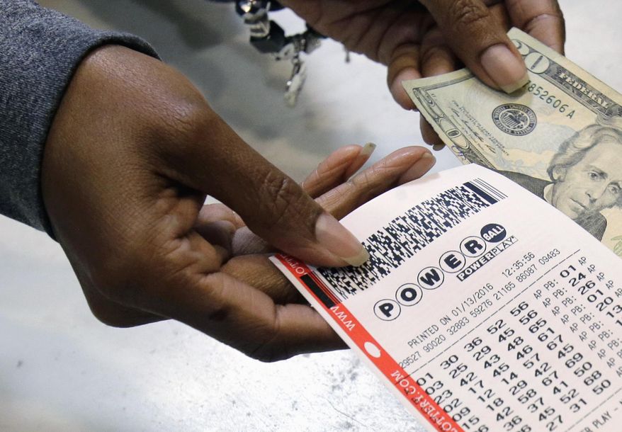 In this Jan. 13, 2016 photo, a clerk hands over a Powerball ticket for cash at Tower City Lottery Stop in Cleveland. The Associated Press has learned that the group that runs Powerball approved, then backed off, changes that would have given ticket buyers more bang for their two bucks than the game redesign implemented last year. In October, Powerball managers changed the game's matrix in a bid to build bigger jackpots to revive lagging player interest and ticket sales. (AP Photo/Tony Dejak, File)