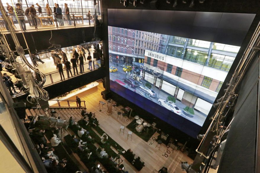 The exterior of Samsung's flagship store, Samsung 837, is shown on a video wall during a media preview of the facility, in New York's Meatpacking District, Monday, Feb 22, 2016. Samsung is opening what it calls a "technology playground" in New York for customers to check out its latest gadgets. The center opens Tuesday, the day Samsung starts taking orders for its upcoming Galaxy S7 and S7 Edge phones. (AP Photo/Richard Drew)