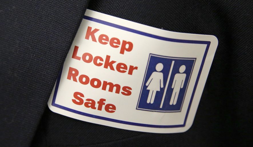 In this Jan. 27, 2016, file photo, a sticker that reads, "Keep Locker Rooms Safe," is worn by a person supporting a bill that would eliminate Washington's new rule allowing transgender people use gender-segregated bathrooms and locker rooms in public buildings consistent with their gender identity, at the Capitol in Olympia, Wash. (AP Photo/Ted S. Warren, File)