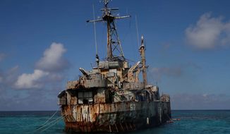 A dilapidated Philippine Navy ship LT 57 (Sierra Madre) with Philippine troops deployed on board is anchored off Second Thomas Shoal, locally known as Ayungin Shoal, Sunday, March 30, 2014 off South China Sea. On Saturday, China Coast Guard attempted to block the Philippine government vessel AM700 carrying fresh troops and supplies, but the latter successfully managed to docked beside the ship to replace troops who were deployed for five months. (AP Photo/Bullit Marquez) (Associated Press)