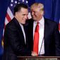 Donald Trump greets Mitt Romney on Feb. 2, 2012, after announcing his endorsement of the former Massachusetts governor during a news conference in Las Vegas. (Associated Press)