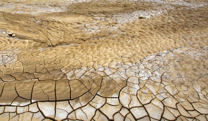 This Feb. 20, 2016 photo shows the dry, cracked lakebed of Trou Caiman, in Croix-des-Bouquets, Haiti. A drought worsened by the El Nino weather phenomenon has driven Haitians who were already barely getting by on marginal farmland deeper into misery. An estimated 1.5 million people are going hungry as crop yields fall to lowest levels in 35 years in a country where two-thirds of people eke out a living from agriculture. (AP Photo/Dieu Nalio Chery)