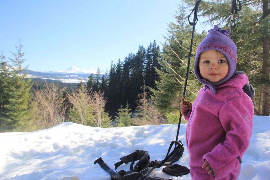 In this Feb. 8, 2016, photo, Lucy Urness poses for a photo at the Three Sisters viewpoint area on the Isaac Nickerson snowshoe loop in Oregon. The route travels second-growth forest to spectacular views of the Three Sisters, Mount Washington and Three Fingered Jack. (Zach Urness/Statesman-Journal via AP) MANDATORY CREDIT