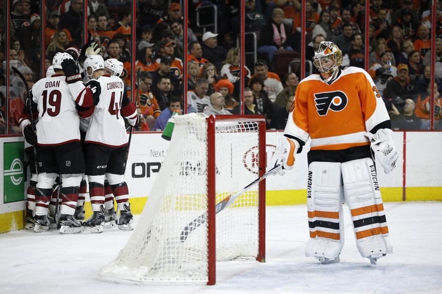 Arizona Coyotes' Shane Doan (19) and Kevin Connauton (44) celebrate after a goal by teammate Brad Richardson past Philadelphia Flyers' Michal Neuvirth (30) during the first period of an NHL hockey game, Saturday, Feb. 27, 2016, in Philadelphia. (AP Photo/Matt Slocum)
