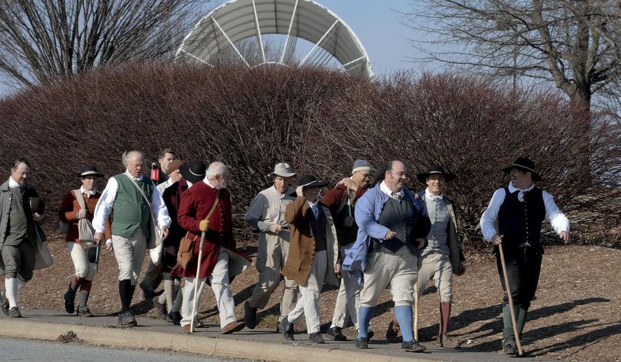 ADVANCE FOR SATURDAY FEB. 27 AND THEREAFTER - In a Feb. 19, 2016 photo, costumed walkers pass Joel Coliseum on University Parkway as they recreate the walk of 10 single Moravian men from Bethabara to Salem to help mark the 250th anniversary of Old Salem in Winston-Salem, NC. This year marks the 250th anniversary of Salem’s founding, and the Moravian Church, Old Salem, the city of Winston-Salem and Forsyth County are planning a yearlong celebration. (David Rolfe /The Winston-Salem Journal via AP) MANDATORY CREDIT
