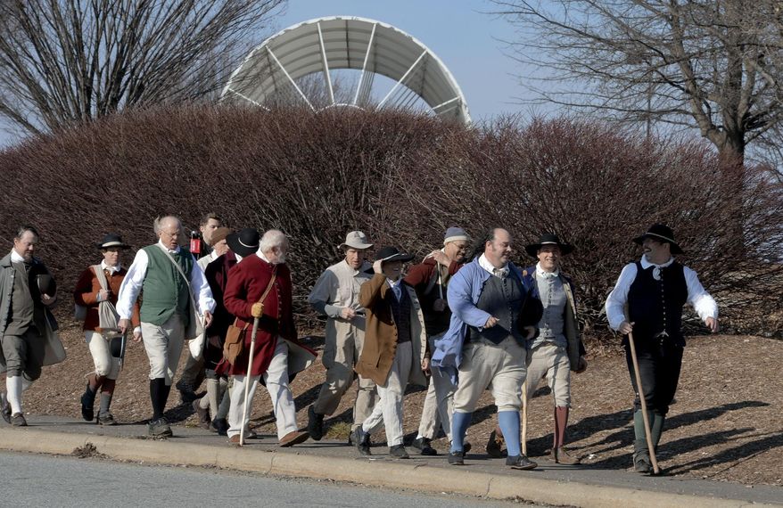 ADVANCE FOR SATURDAY FEB. 27 AND THEREAFTER - In a Feb. 19, 2016 photo, costumed walkers pass Joel Coliseum on University Parkway as they recreate the walk of 10 single Moravian men from Bethabara to Salem to help mark the 250th anniversary of Old Salem in Winston-Salem, NC. This year marks the 250th anniversary of Salem’s founding, and the Moravian Church, Old Salem, the city of Winston-Salem and Forsyth County are planning a yearlong celebration. (David Rolfe /The Winston-Salem Journal via AP) MANDATORY CREDIT