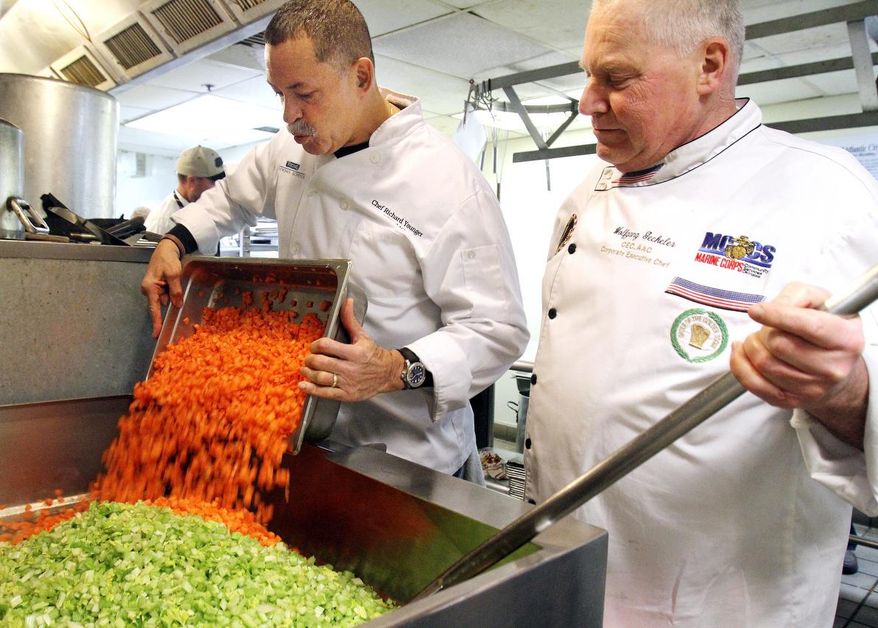This Feb. 11, 2016, photo shows chefs Richard Younger, left, and Wolfgang Geckeler, who are part of a group of 50 area professional chefs that volunteer their time to prepare soup in the kitchen of the Atlantic City Rescue Mission. The chefs hope to reach a goal of preparing over 50,000 bowls of soup in 2016 for Bowls for Hearts and Souls program. (Viviana Pernot/The Press of Atlantic City via AP)