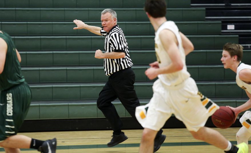 FOR RELEASE SATURDAY, FEBRUARY 27, 2016, AT 12:01 A.M. CST.- Iowa state Rep. Chuck Isenhart, D-Dubuque, officiates a basketball game at Hempstead High School in Dubuque, Iowa, on Friday, Feb. 12, 2016. (Nicki Kohl/Telegraph Herald via AP)