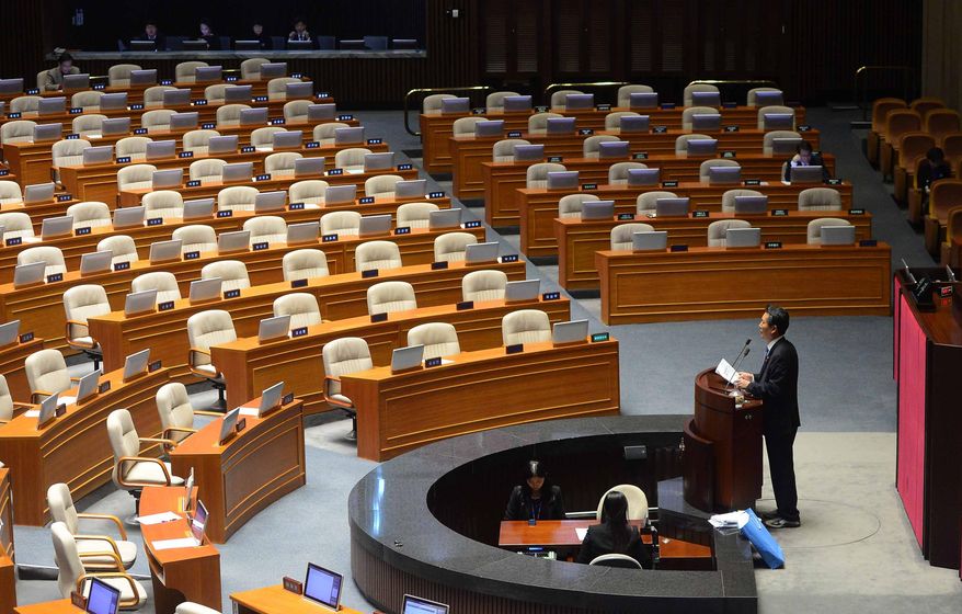 Rep. Jung Cheong Rae, right, of the main opposition Minjoo Party of Korea speaks at the National Assembly in Seoul, South Korea, Saturday, Feb. 27, 2016. South Korea's opposition lawmakers on Saturday continued their nonstop speeches for a fifth straight day in parliament to block a vote on a government-backed anti-terrorism bill that they say would threaten personal freedoms and privacy if passed into law. (Kim Hyun-tae/Yonhap via AP) KOREA OUT