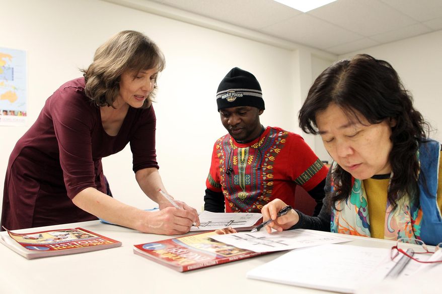 Susan Prepejchal works with 20-year-old Cedrick Buhendwa, a native of the Democratic Republic of the Congo, during an English class as part of the Friendship Community Project held at Good News Bible Church on Monday, Feb. 15, 2016 in Iowa City, Iowa. The Friendship Community Project started offering the volunteer-led classes in September to help adults from outside the U.S. learn English and navigate changes that come with moving to a new country, such as getting health insurance or addressing traffic tickets, said Susan Prepejchal, one of the project's teachers. (David Scrivner /Iowa City Press-Citizen via AP) NO SALES; MANDATORY CREDIT