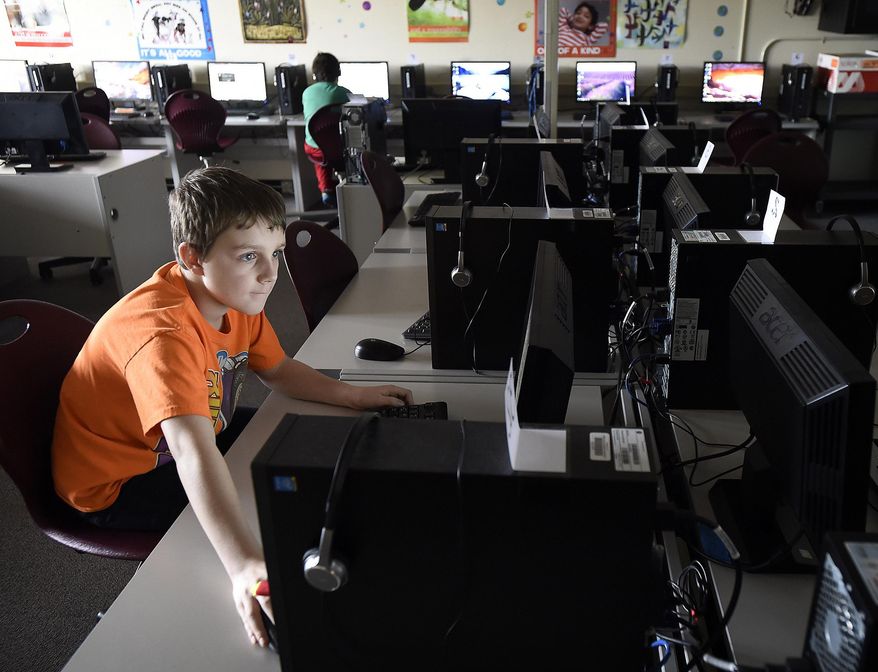 In this Feb. 16, 2016 photo, Adams Elementary fifth grade student Brennan Stevenson, 10, works on his project before the start of the Programming Club meeting in Corvallis, Ore. (Andy Cripe/The Corvallis Gazette-Times via AP) MANDATORY CREDIT