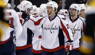 Washington Capitals&#39; Brooks Laich (21) celebrates with teammates after the Capitals defeated the Boston Bruins 3-2 during an NHL hockey game in Boston, Tuesday, Jan. 5, 2016. (AP Photo/Michael Dwyer)