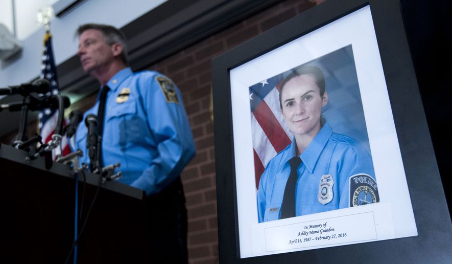 Prince William County Police Chief Stephan Hudson speaks during a news conference next to a picture of Officer Ashley Guindon at Western District Station in Manassas, Va., on Sunday. Saturday's killing of Guindon marks the most recent line of duty death this year. (Associated Press)