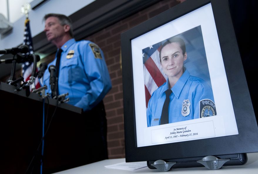 Prince William County Police Chief Stephan Hudson speaks during a news conference next to a picture of Officer Ashley Guindon at Western District Station in Manassas, Va., on Sunday. Saturday's killing of Guindon marks the most recent line of duty death this year. (Associated Press)