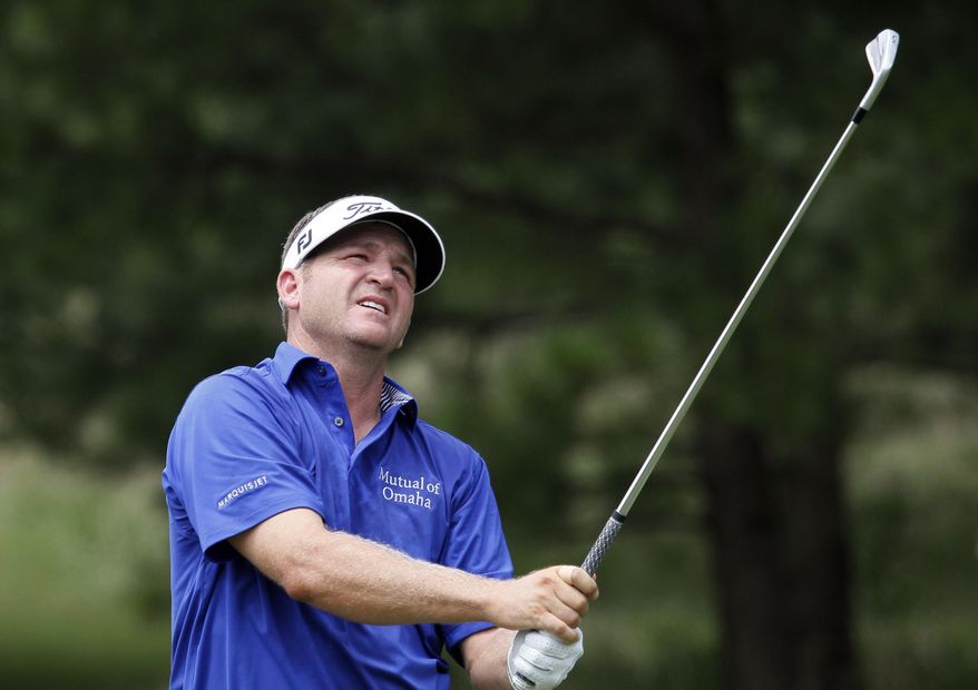 FILE - In this July 22, 2012, file photo, Jason Bohn watches his drive from the second hole tee box in the fourth round of the True South Classic golf tournament in Madison, Miss. Bohn says he wanted to go back to his room to take a shower before going to the hospital with chest pains and did not realize he was having a major heart attack until paramedics put him on a stretcher and called for an ambulance. (AP Photo/Rogelio V. Solis, File)