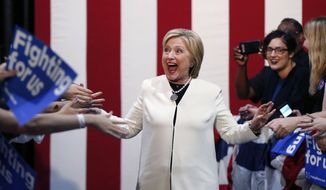 Democratic presidential candidate Hillary Clinton reacts to supporters as she arrives to speak at her Super Tuesday election night rally in Miami, Tuesday, March 1, 2016. (AP Photo/Gerald Herbert)