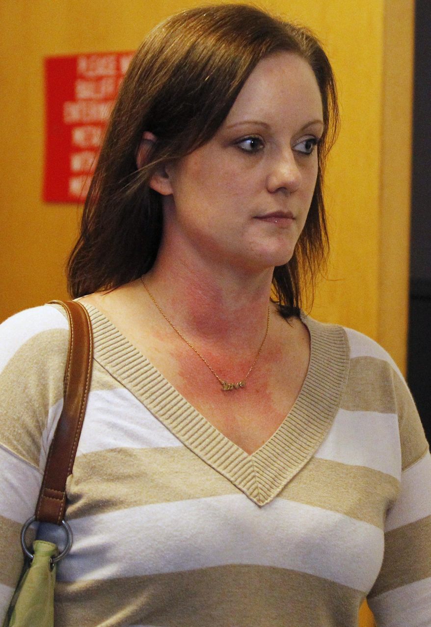 In this Dec. 17, 2015 photo, Alissa Jackson, of Belleville, Ill., leaves the courtroom at the St. Clair County Building in Belleville. Jackson, who pleaded guilty to lying about a terminal ovarian cancer diagnosis, is scheduled to be sentenced Tuesday, March 1, 2016. Jackson was a married mother of five when she was charged in June 2014 with bilking thousands of dollars in donations, free food and a donated minivan from hundreds of people on behalf of "Alissa's Army." (Zia Nazami/Belleville News-Democrat via AP)