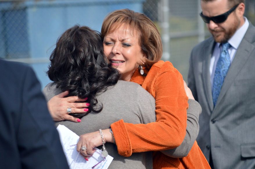 New Mexico Gov. Susana Martinez, center, hugs a family member of a victim of a drunken driving accident, during a press conference in Albuquerque on Tuesday, March 1, 2016. The Republican governor signed a bill Tuesday aimed at strengthening some drunken driving penalties. The bill makes it a second-degree felony to be convicted of eight or more DWIs, meaning tougher sentencing guidelines would be imposed. The measure also substantially increases penalties for convicted drunk drivers involved in fatal crashes. (AP Photo/Russell Contreras)