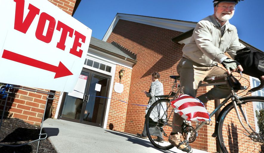 In this file photo, David Ray rides his bike away from his polling place after voting in the primary election Tuesday, March 1, 2016 in Winchester, Va. On Oct. 20, 2016, a federal judge extended the voter-registration deadline in the Old Dominion to Friday, Oct. 21. (Jeff Taylor/The Winchester Star via AP) MANDATORY CREDIT **FILE**