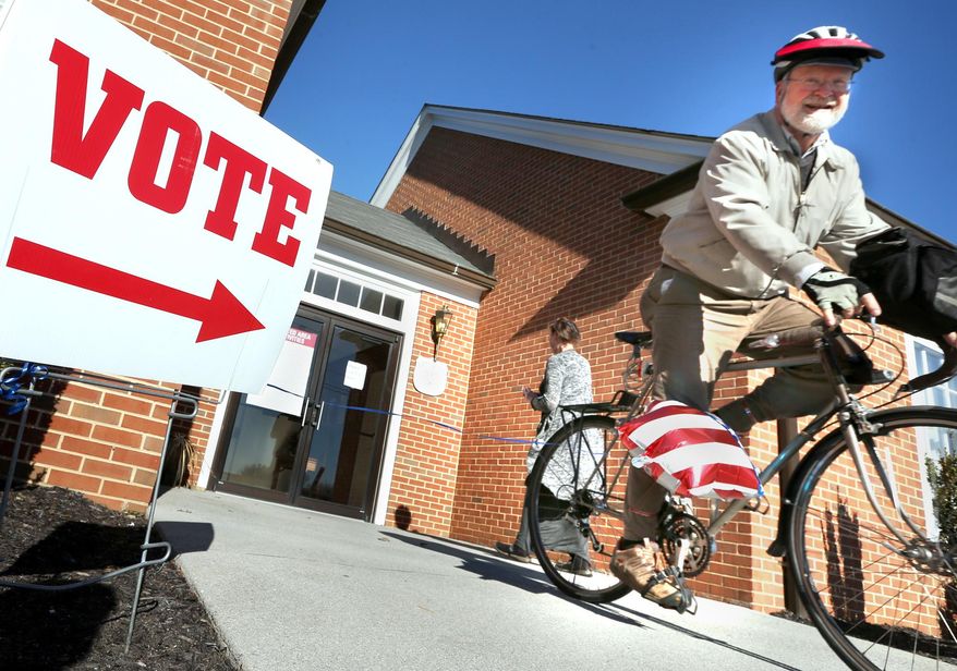 In this file photo, David Ray rides his bike away from his polling place after voting in the primary election Tuesday, March 1, 2016 in Winchester, Va. On Oct. 20, 2016, a federal judge extended the voter-registration deadline in the Old Dominion to Friday, Oct. 21. (Jeff Taylor/The Winchester Star via AP) MANDATORY CREDIT **FILE**