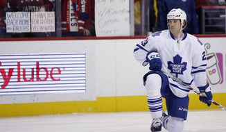 Fans hold signs as Toronto Maple Leafs center Brooks Laich warms up before an NHL hockey game against the Washington Capitals, Wednesday, March 2, 2016, in Washington. (AP Photo/Alex Brandon) **FILE**