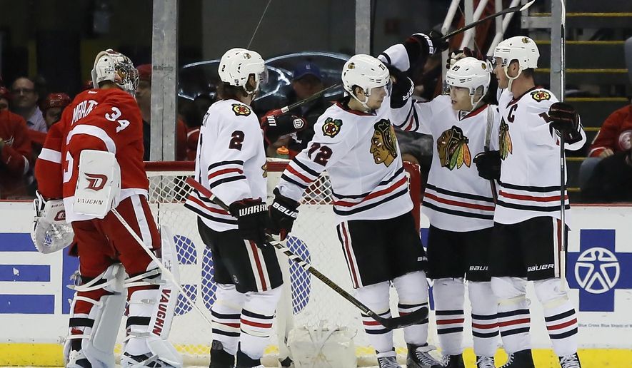 Chicago Blackhawks&#39; Artemi Panarin (72), of Russia, celebrates with teammates Duncan Keith (2), Patrick Kane, second from right, and and Jonathan Toews, right, after scoring on Detroit Red Wings goalie Petr Mrazek (34) during the second period of an NHL hockey game Wednesday, March 2, 2016, in Detroit. (AP Photo/Duane Burleson)