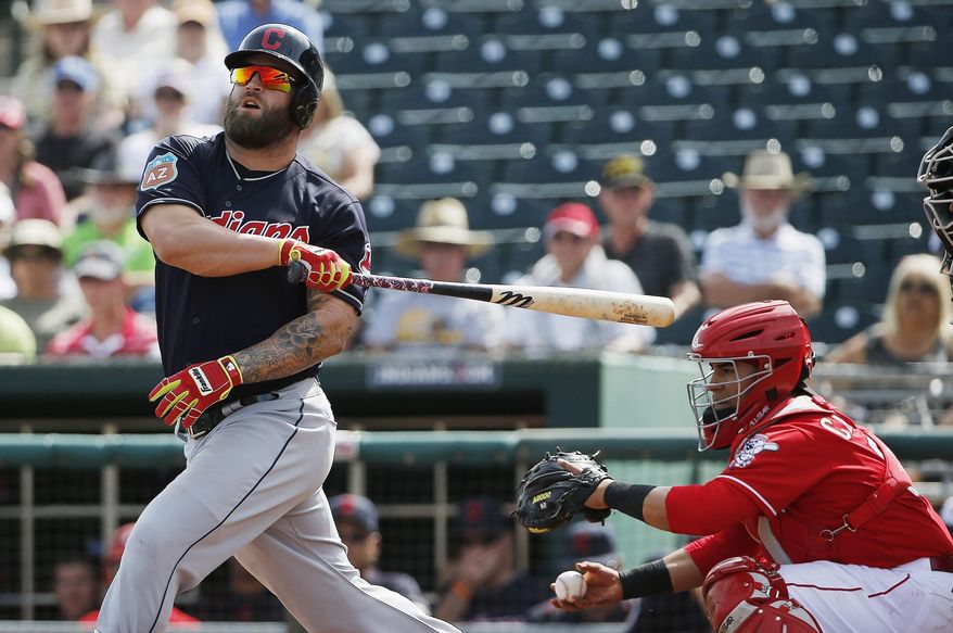 Cleveland Indians&#39; Mike Napoli, left, loses control of his bat as his misses on a swing as Cincinnati Reds catcher Ramon Cabrera, right, holds onto the ball during the first inning of a Cactus League baseball game Wednesday, March 2, 2016, in Goodyear, Ariz. (AP Photo/Ross D. Franklin)