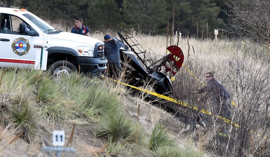 First responders put down a tarp over a small plane that crashed near Palmer Lake, Colo., on Wednesday, March 2, 2016. The crash happened Wednesday morning near Palmer Lake but no other details have been released. The town is near the Air Force Academy but the school told The Gazette of Colorado Springs that the plane isn't one of its aircraft. (Jerilee Bennett/The Gazette via AP) MAGS OUT; MANDATORY CREDIT