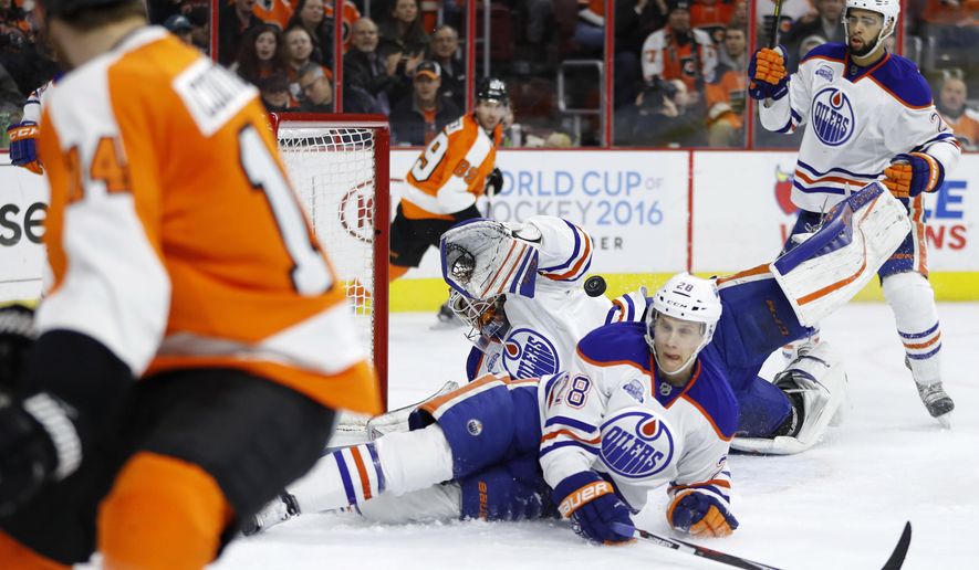 Edmonton Oilers&#39; Cam Talbot, center, blocks a shot by Philadelphia Flyers&#39; Sean Couturier, left, as Oilers&#39; Lauri Korpikoski (28) and Darnell Nurse (25) also defend during the second period of an NHL hockey game, Thursday, March 3, 2016, in Philadelphia. (AP Photo/Matt Slocum)