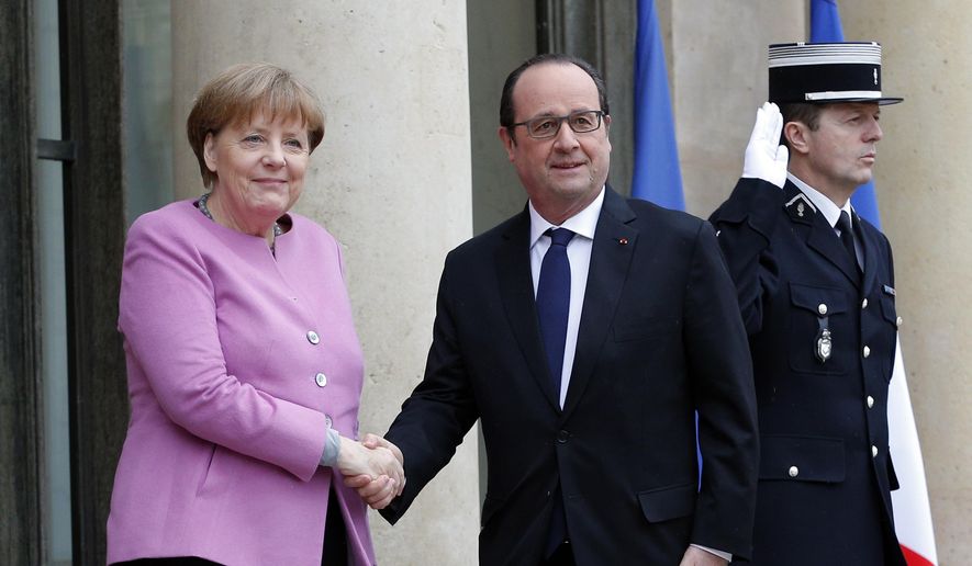 France&#39;s President Francois Hollande, right, welcomes German chancellor Angela Merkel prior to a meeting, at the Elysee Palace, in Paris, Friday, March 4, 2015. (AP Photo/Christophe Ena)