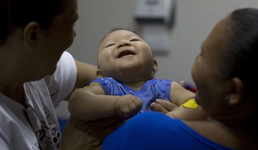 FILE - In this Feb. 25, 2016 file photo, Caio Julio Vasconcelos who was born with microcephaly undergoes physical therapy at the Institute for the Blind in Joao Pessoa, Brazil. Researchers say the Zika virus may be linked to a wider variety of “grave outcomes” for developing babies than previously reported and that threats can come at any stage of pregnancy. (AP Photo/Andre Penner, File)