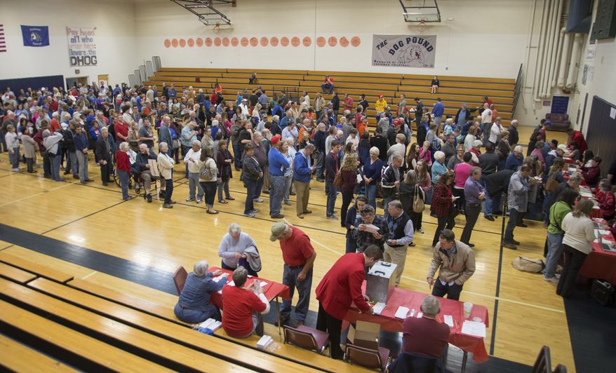 Slow Internet connections delays registration, causing long lines to form at a Republican caucusing site in Lawrence, Kansas Saturday, March 5, 2016. Kansas Republican leaders reported heavy turnout early Saturday as supporters began meeting to weigh in on the 2016 presidential race, while Democrats would start indicating their preferences later in the day. (Mike Yoder/The Lawrence Journal-World via AP) MANDATORY CREDIT