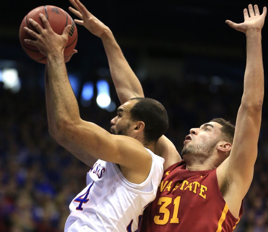 Kansas forward Perry Ellis, left, is fouled by Iowa State forward Georges Niang (31) during the first half of an NCAA college basketball game in Lawrence, Kan., Saturday, March 5, 2016. (AP Photo/Orlin Wagner)