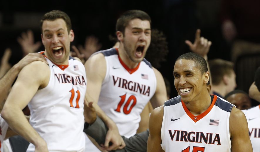 Virginia&#39;s Malcolm Brogdon (15), Evan Nolte (11) and Mike Tobey (10) celebrate during the second half of an NCAA college basketball game against Louisville in Charlottesville, Va., Saturday, March 5, 2016. Virginia won 68-46. (AP Photo/Steve Helber)