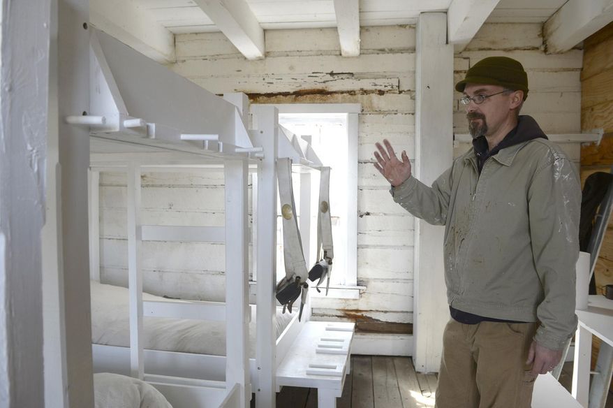 ADVANCE FOR SUNDAY MARCH 6 - In this Monday, Feb. 29, 2016 photo, Dr. Eugene Watkins, of Fort Madison, shows some of the new repairs that is being worked on in the barracks at the Old Fort Madison in Fort Madison, Iowa. Part of Old Fort Madison has a new look for the approaching tourism season. With the first $5,000 installment of a Midwest One grant the fort received last year, site curator Eugene Watkins and site employee Franz Hoenig have been creating more accurate depictions of rooms in the soldier's barracks, including bunk beds and white-washed walls and decor. (Jeff Brown/The Hawk Eye via AP) MANDATORY CREDIT